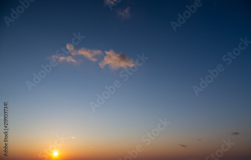 The summer sun sinking below the horizon