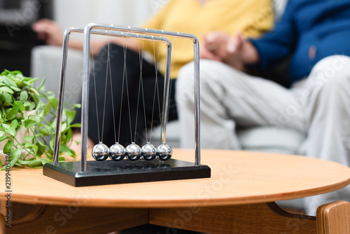 Newton's cradle on wooden table.