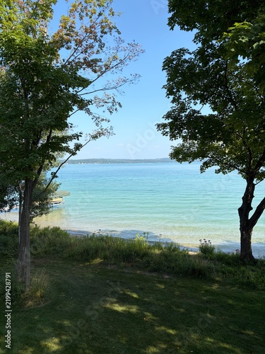 peaceful view of the crystal-clear turquoise waters of Torch Lake 