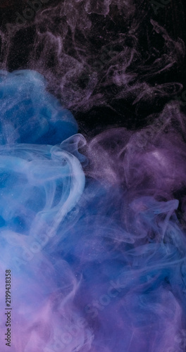 Color smog splash. Paint texture. Defocused blue purple vibrant art particles chemical underwater fog water pigment spreading on acrylic abstract background.