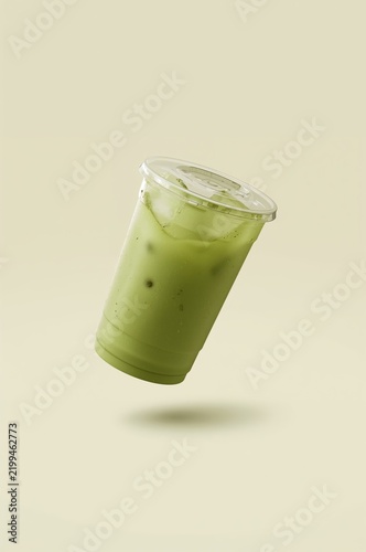 Matcha Drink in a Cup Floating in the Air Against a Plain Background