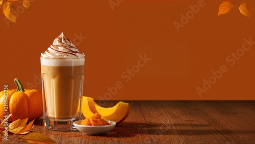 Pumpkin Spice Latte Served With Pumpkin Slices and Dessert on a Wooden Table