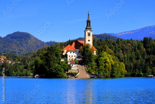 Lake Bled, Slovenia: Scenic view of the Assumption of Mary Church on the island with Bled Castle on a cliff and mountains