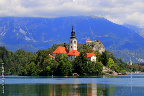 Lake Bled, Slovenia: Scenic view of the Assumption of Mary Church on the island with Bled Castle on a cliff and mountains