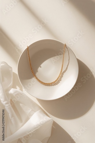 Jewelry Placed on a White Plate With Natural Light Shining on It