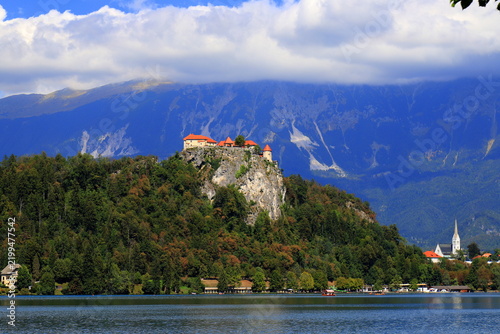 Lake Bled, Slovenia: Beautiful view of the old castle on a high rock near the lake. Beautiful blue mountains