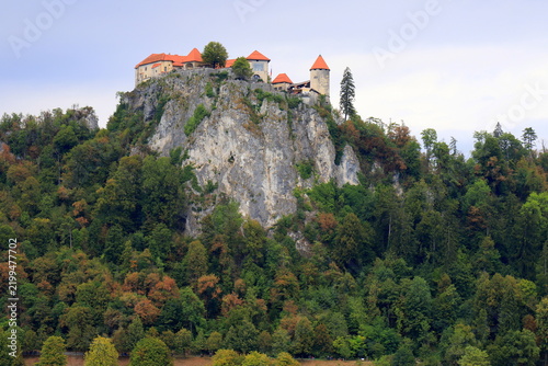 Lake Bled, Slovenia: Beautiful view of the old castle on a high rock near the lake. Beautiful blue mountains