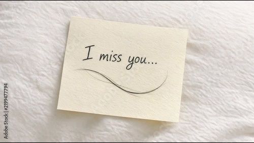 A handwritten note with the words 'I miss you' written on it, often used in emotional or sentimental contexts