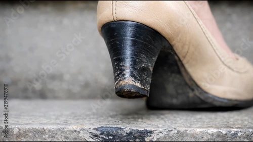 A close-up of a person's shoe on a step, perfect for use in travel or lifestyle 