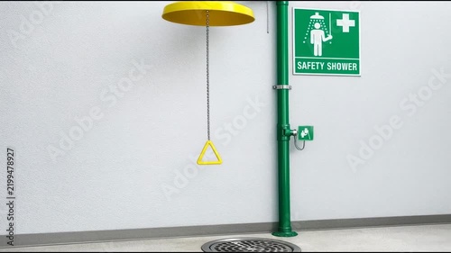 A yellow light hangs from a green pole, suitable for scenes with caution or warning