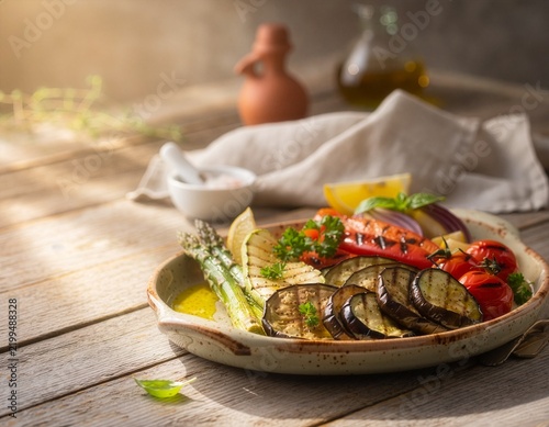 close-up of grilled vegetable platter with eggplant asparagus cherry tomatoes bell pepper lemon and fresh herbs in rustic setting