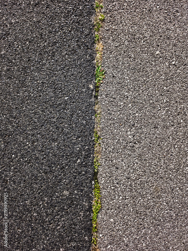 Close-up of rough asphalt texture. Dark and light asphalt. texture of dark asphalt road surface for transportation background, urban infrastructure design. Vertical photo