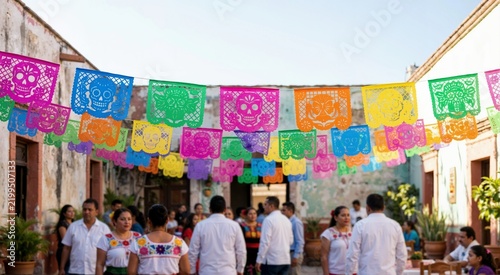 Mexican papel picado banners hanging over traditional fiesta courtyard. People celebrating festival