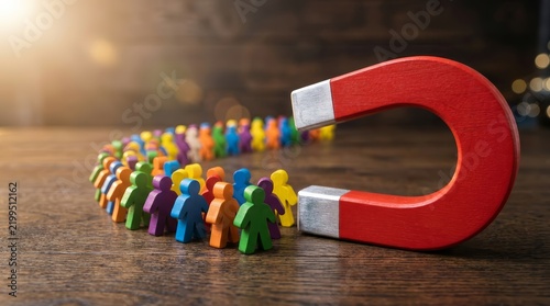 Business lead generation strategy shown by a magnet attracting a diverse group of colorful human figures.