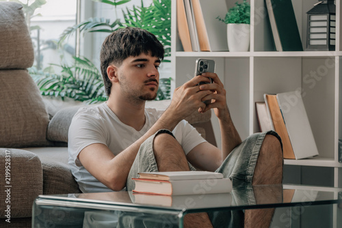 Student at home checking mobile phone