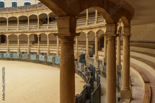 Weathered wooden barrier panels along the curved wall of Ronda's bullring