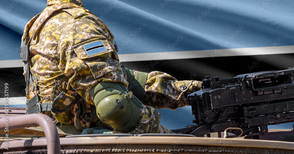 Obraz premium Botswana flag with soldier at machinegun turret