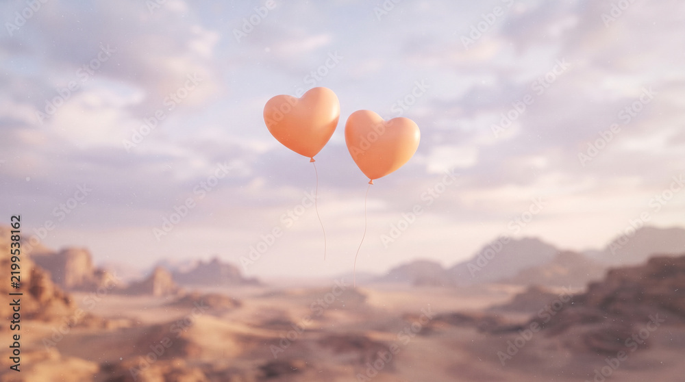 Fototapeta premium Two heart shaped balloons floating over desert landscape at sunset