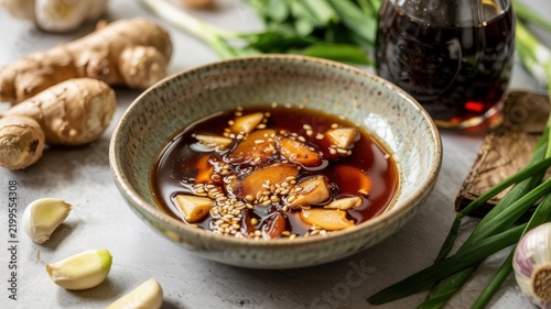 Asian cuisine: Ginger Soy Stir-Fry Sauce — a savory sauce based on soy sauce, enhanced with the spiciness of ginger root, garlic slices, sesame seeds, and green onions.