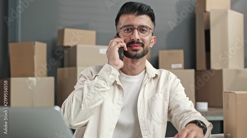 Man talks on phone, focused and serious