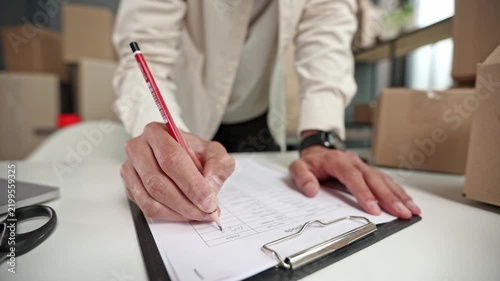 Hand writes on document with red pencil