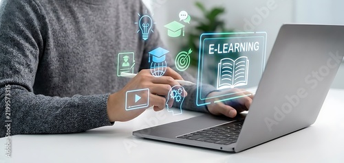 Person using laptop with glowing E-learning interface and educational icons floating above online education