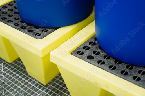 Картината върху платно Two drums rest above removable grates on separate containment platforms, showing