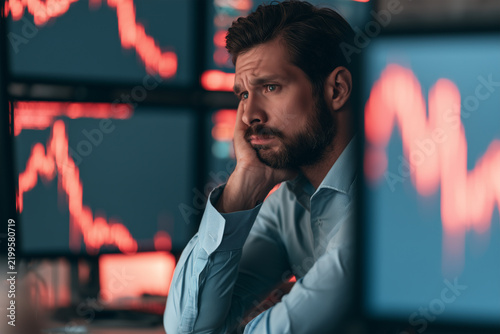 Investor looks worried while monitoring stock market trends