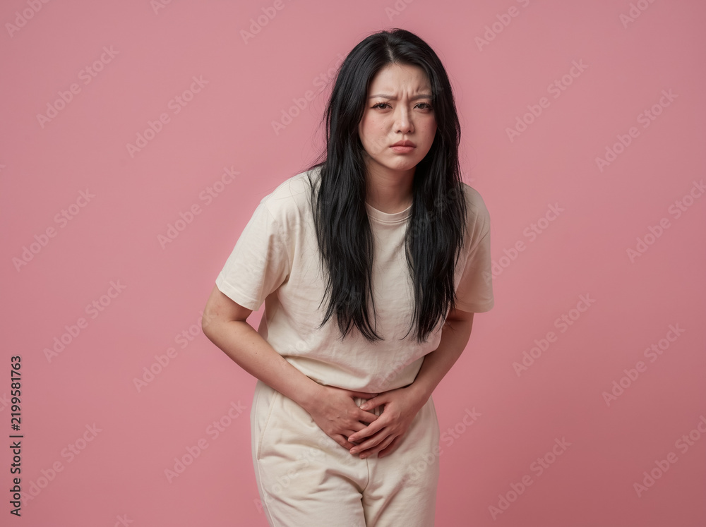 Fototapeta premium Woman bending forward with abdominal cramps