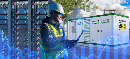 Energy storage industry, engineer monitors battery storage systems and electrical equipment for storing and redistributing generated energy.
