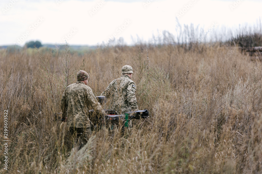 Fototapeta premium Ukrainian soldiers preparing heavy bomber drone for combat mission