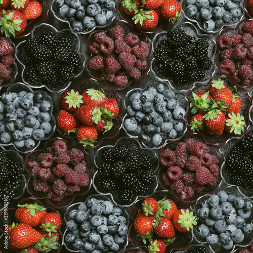 Vertical Flat Lay Of Mixed Berries On A Dark Background. Blueberries Blackberries Raspberries And Strawberries Top View. Rich Fruit Pattern