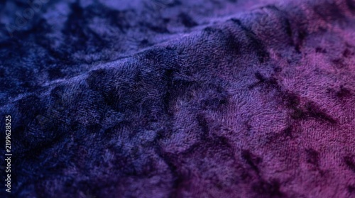 Textured purple crushed velvet fabric background.