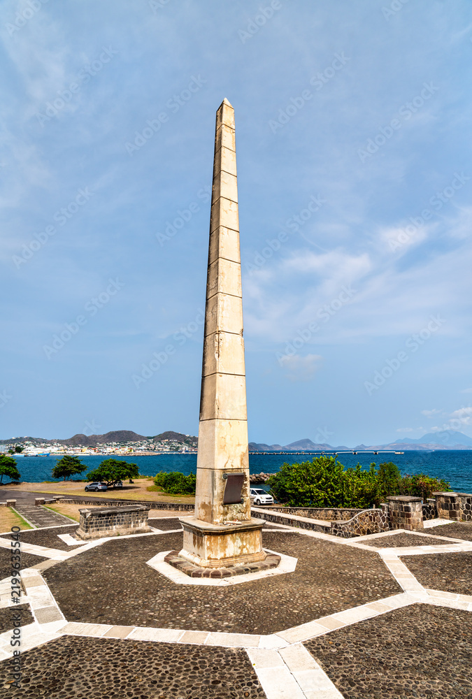 Obraz premium A view of the historic War Memorial obelisk standing on the waterfront in Basseterre, Saint Kitts and Nevis, under a clear sky