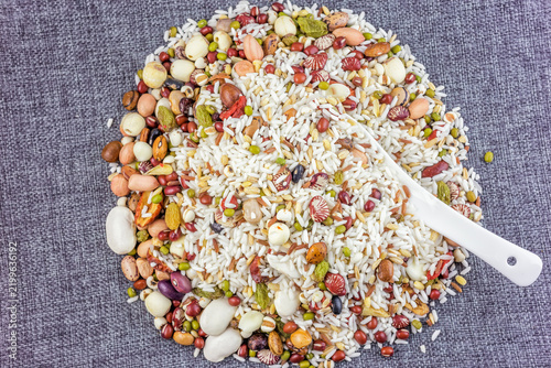 Fotografie A pile of mixed raw grains, legumes, seeds and dried fruits, ideal for cooking nutritious porridge or dishes