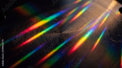 Abstract Macro Shot of Light Diffraction on Brushed Metal Surface Creating Prismatic Rainbow Spectrum Streaks and Vibrant Colorful Glow for Futuristic Technology Background and Creative Concepts