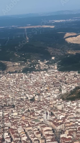 Aerial view of Istanbul from airplane window with plane shadow on the city