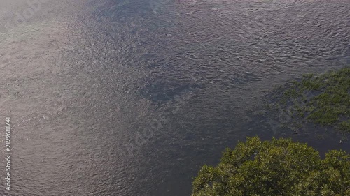 Aerial view of a hydroelectric power plant on a wide river in summer