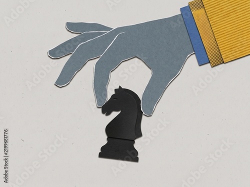 Strategic Business Move Concept with Paper Cut Illustration of a Hand Moving a Chess Knight Piece