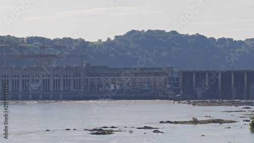 Aerial pan of a large hydroelectric power plant and river dam