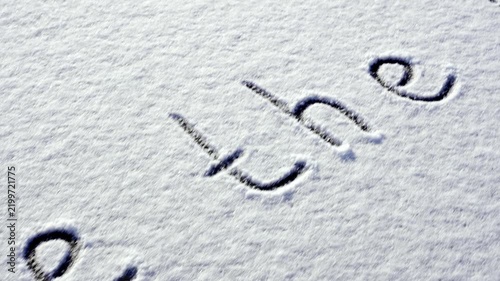 Written SAVE THE PLANET on snow background message ice outdoor on ground in winter. Writing text sign drawing on field in frozen background. Weather changing cold season has arrived environment