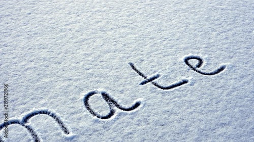 Written CLIMATE CHANGE on snow background message ice outdoor on ground in winter. Writing text sign drawing on field in frozen background. Weather changing cold season has arrived environment