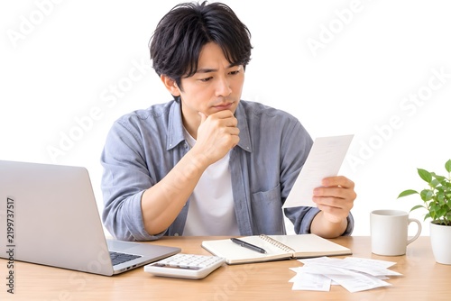 Japanese Man Reviewing Bills and Monthly Expenses at Home