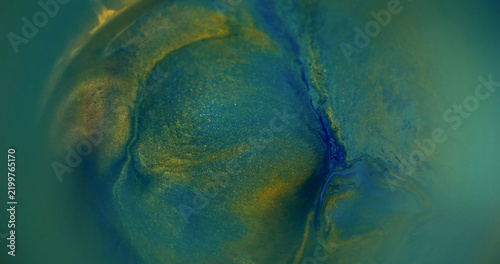 Blur ink texture. Color glitter pigment. Yellow blue green swirl paint bright fluid round liquid rainbow spill on abstract background.