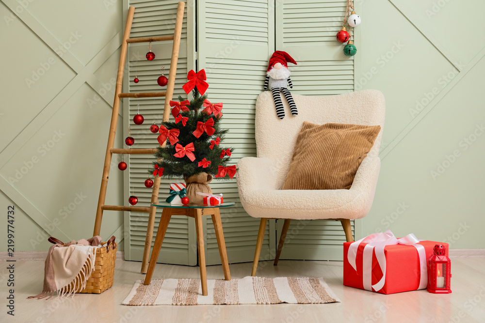 Obraz premium Christmas home interior, holiday season celebration with decorated tree and gifts in cozy living room with armchair and festive ornaments