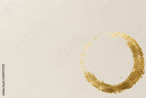 Broken gold halo on textured beige background creates minimalist and elegant design. This artistic element adds touch of luxury and sophistication