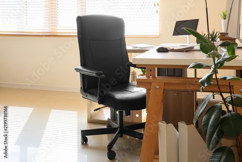 Comfortable black chair in modern office interior
