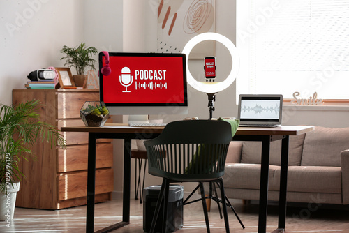Interior of podcasters studio with workplace, sofa and plants