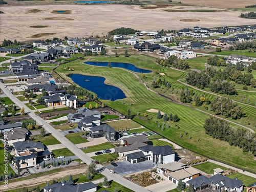 Drone shot of new suburban homes near a pond