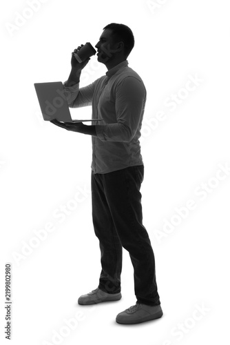 Silhouette of businessman with laptop drinking coffee on white background
